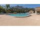 Large community pool is surrounded by brick pavers, mature trees, and lounge chairs at 284 Quane Ave, Spring Hill, FL 34609