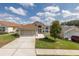 Charming single-story home with an attached two-car garage, manicured lawn, and a pristine front yard at 284 Quane Ave, Spring Hill, FL 34609