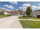 Charming single-story home featuring an attached two-car garage, manicured landscaping, and a pristine front yard at 284 Quane Ave, Spring Hill, FL 34609