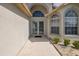 Inviting front entrance with double doors, enhanced by an arched window and decorative landscaping at 284 Quane Ave, Spring Hill, FL 34609