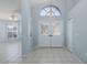 Bright foyer featuring double doors, tile flooring, and an arched window for natural light at 284 Quane Ave, Spring Hill, FL 34609