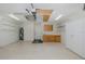 Spacious garage with cabinets, shelves, and water heater for ample storage and functionality at 284 Quane Ave, Spring Hill, FL 34609