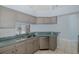Bright kitchen with a stainless steel dishwasher, sink, and lots of storage at 284 Quane Ave, Spring Hill, FL 34609