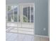 View of patio with tile flooring and vertical blinds covering sliding doors at 284 Quane Ave, Spring Hill, FL 34609