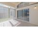 Sunroom featuring sliding glass doors, carpet, and abundant natural light from surrounding windows at 284 Quane Ave, Spring Hill, FL 34609