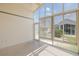 Bright sunroom features tile flooring and a wall of windows offering lots of natural light and outdoor views at 284 Quane Ave, Spring Hill, FL 34609