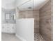 Modern bathroom featuring a glass-enclosed shower with wood-look tile and a double vanity at 305 Yellow Elder, Punta Gorda, FL 33955