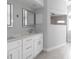 Bright bathroom featuring double vanity with white cabinets, quartz counters, and modern fixtures at 305 Yellow Elder, Punta Gorda, FL 33955