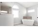 Relaxing bathroom showcasing a freestanding tub with a modern faucet and large windows for natural light at 305 Yellow Elder, Punta Gorda, FL 33955