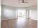 Open bedroom featuring a ceiling fan, luxury vinyl plank flooring, and sliding glass doors at 305 Yellow Elder, Punta Gorda, FL 33955