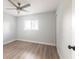 Sunlit bedroom featuring light wood floors, a ceiling fan, and a window at 305 Yellow Elder, Punta Gorda, FL 33955