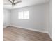 Spacious bedroom with light wood floors, a ceiling fan, and natural light from a window at 305 Yellow Elder, Punta Gorda, FL 33955