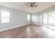 Bedroom features a ceiling fan, vinyl flooring, and sliding glass doors to the exterior at 305 Yellow Elder, Punta Gorda, FL 33955