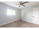 This bedroom has neutral walls, sleek ceiling fan, closet, and a window for great natural light at 305 Yellow Elder, Punta Gorda, FL 33955