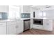 Bright kitchen features stainless steel appliances, white cabinetry and tile backsplash at 305 Yellow Elder, Punta Gorda, FL 33955