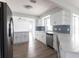 Open kitchen boasts stainless steel appliances, white cabinets, and a tile backsplash at 305 Yellow Elder, Punta Gorda, FL 33955