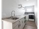 Laundry room with granite countertops, stainless steel sink and modern black hardware at 305 Yellow Elder, Punta Gorda, FL 33955