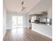 Open living area showcasing slider door, and view into modern white kitchen at 305 Yellow Elder, Punta Gorda, FL 33955
