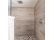 Close-up of a tiled shower with pebble flooring and a rainfall shower head at 305 Yellow Elder, Punta Gorda, FL 33955