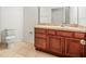 Bathroom featuring tile floors, wooden cabinets, and a mirror at 3885 Crossline Dr, Spring Hill, FL 34609