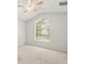 Bright bedroom featuring a large arched window and ceiling fan at 3885 Crossline Dr, Spring Hill, FL 34609