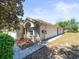 Exterior side view of a well-maintained house with a walkway and manicured landscaping, exuding curb appeal at 3885 Crossline Dr, Spring Hill, FL 34609