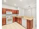 Modern kitchen with a breakfast bar, granite counters, and tile floors at 3885 Crossline Dr, Spring Hill, FL 34609
