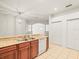 Open kitchen offers granite countertops and stainless steel sink at 3885 Crossline Dr, Spring Hill, FL 34609