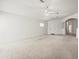Inviting living room with neutral carpeting, ample natural light, and a clean, minimalist aesthetic at 3885 Crossline Dr, Spring Hill, FL 34609