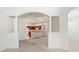 Bright living room featuring architectural columns and an open view to the kitchen at 3885 Crossline Dr, Spring Hill, FL 34609