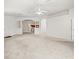 Spacious living room with arched entryway showing the kitchen, providing a sense of openness and connection at 3885 Crossline Dr, Spring Hill, FL 34609