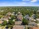 Residential neighborhood showing rooftops, green trees, and lush landscaping from an aerial perspective at 4330 Crosswhite Ct, Spring Hill, FL 34609