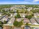 An aerial shot captures a well-planned neighborhood with pools and lush landscaping under a clear sky at 4330 Crosswhite Ct, Spring Hill, FL 34609