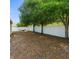 Spacious backyard featuring a white fence, mature trees, and a relaxing hammock at 4330 Crosswhite Ct, Spring Hill, FL 34609