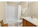 Bathroom featuring a shower-tub combo, white tile and a wood vanity at 4330 Crosswhite Ct, Spring Hill, FL 34609