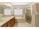 Bathroom featuring double sinks, white countertops and a walk-in shower at 4330 Crosswhite Ct, Spring Hill, FL 34609