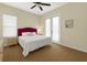 Bedroom with a red headboard featuring a queen bed and a window at 4330 Crosswhite Ct, Spring Hill, FL 34609