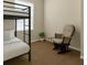 Bedroom with a bunk bed and rocking chair by a window at 4330 Crosswhite Ct, Spring Hill, FL 34609