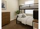 Cozy bedroom featuring a black bunk bed, dresser, and neutral decor at 4330 Crosswhite Ct, Spring Hill, FL 34609