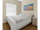 Bright bedroom featuring a white queen bed and soft natural lighting at 4330 Crosswhite Ct, Spring Hill, FL 34609
