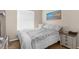 Bright bedroom featuring a queen bed with a grey blanket and soft natural lighting at 4330 Crosswhite Ct, Spring Hill, FL 34609