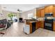 A kitchen shows wooden cabinets, modern appliances, and a view into the living room at 4330 Crosswhite Ct, Spring Hill, FL 34609