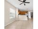 Open-concept living room, dining, and kitchen area with tile floors and neutral walls at 4330 Crosswhite Ct, Spring Hill, FL 34609