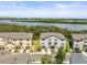 Scenic aerial view showcasing townhomes with waterfront views and well-maintained landscaping at 4740 Tuscan Loon Dr, Tampa, FL 33619