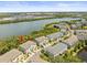Aerial view of modern townhomes near a tranquil river and lush greenery at 4740 Tuscan Loon Dr, Tampa, FL 33619