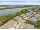 An aerial view of a neighborhood with townhomes near a large body of water at 4740 Tuscan Loon Dr, Tampa, FL 33619