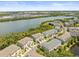 Overhead view of townhomes near a tranquil river and green space in a neighborhood setting at 4740 Tuscan Loon Dr, Tampa, FL 33619