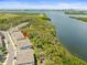 Spectacular aerial view of waterfront townhouses nestled among lush greenery and serene waters at 4740 Tuscan Loon Dr, Tampa, FL 33619