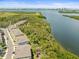 Scenic aerial view highlighting waterfront townhomes set against a backdrop of lush greenery at 4740 Tuscan Loon Dr, Tampa, FL 33619