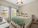 Bright bedroom featuring dual windows, neutral walls and decor and a ceiling fan at 4740 Tuscan Loon Dr, Tampa, FL 33619